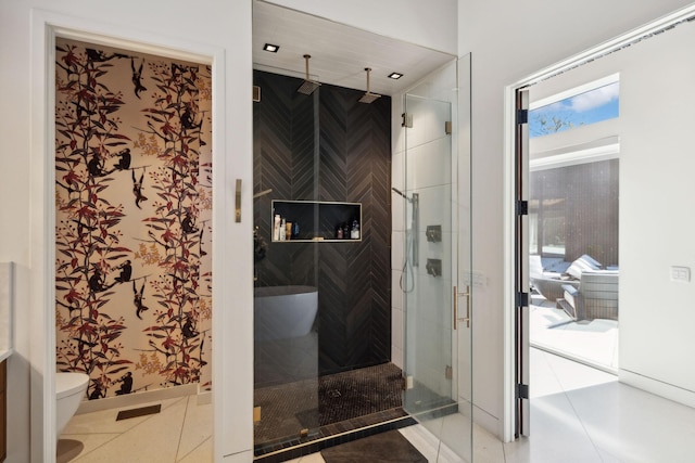 bathroom with toilet, tile patterned flooring, and walk in shower