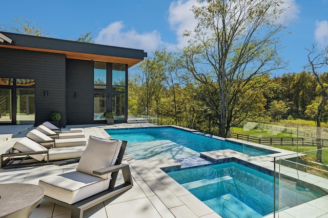 view of pool with an in ground hot tub