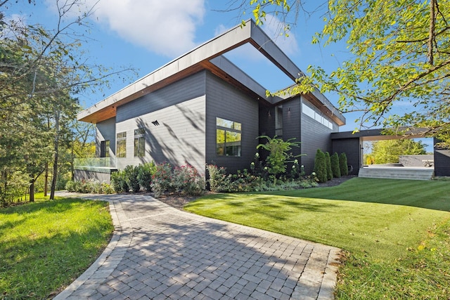 view of side of home with a yard