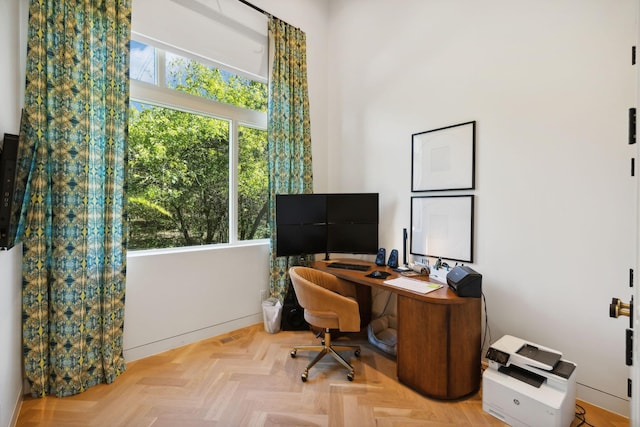 office area with light parquet floors and plenty of natural light