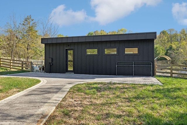 view of outbuilding with a yard