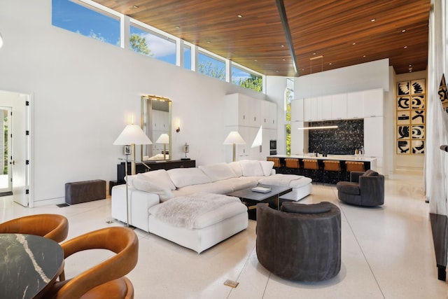 living room featuring a towering ceiling and wood ceiling