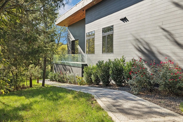 view of side of home featuring a lawn