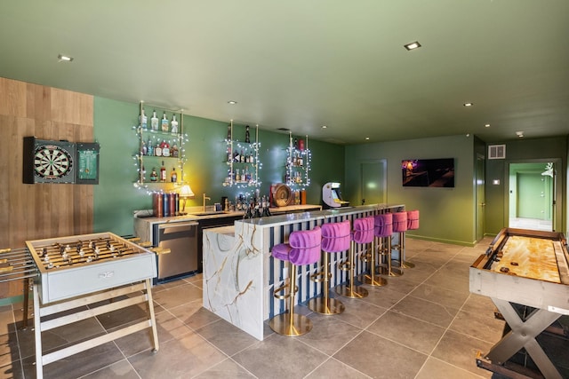 bar with dishwasher and light tile patterned floors