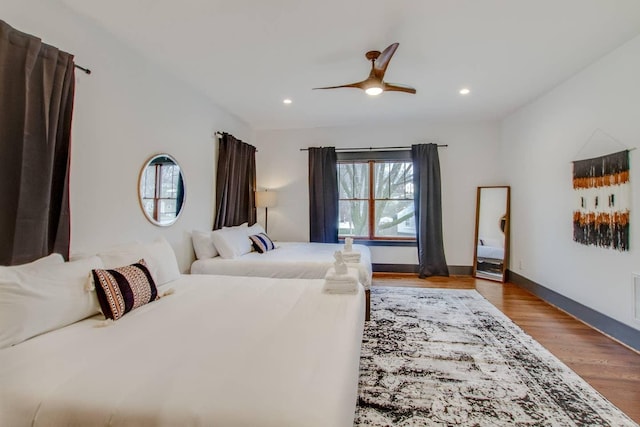 bedroom with ceiling fan and light hardwood / wood-style floors