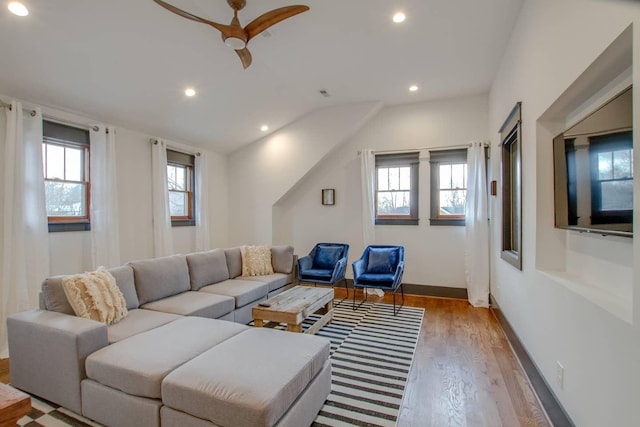 living room featuring light wood-type flooring and ceiling fan