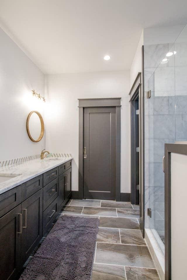 bathroom with a shower with door and vanity