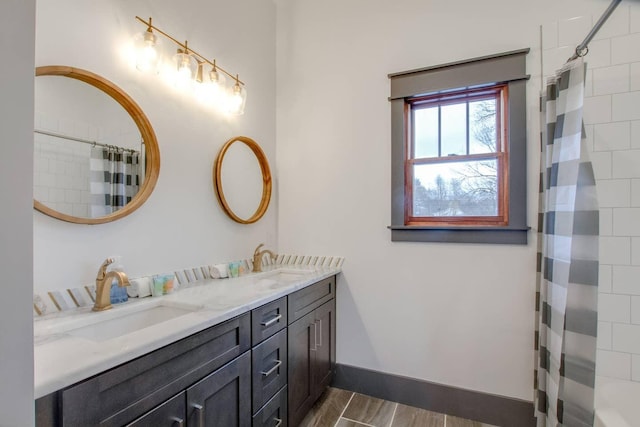 bathroom featuring vanity and curtained shower