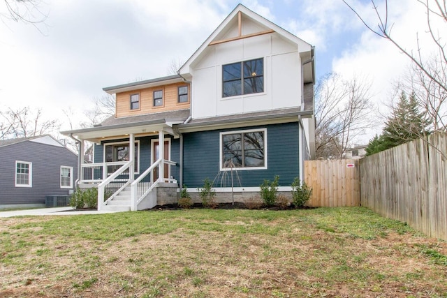 view of front of home with central air condition unit and a front lawn