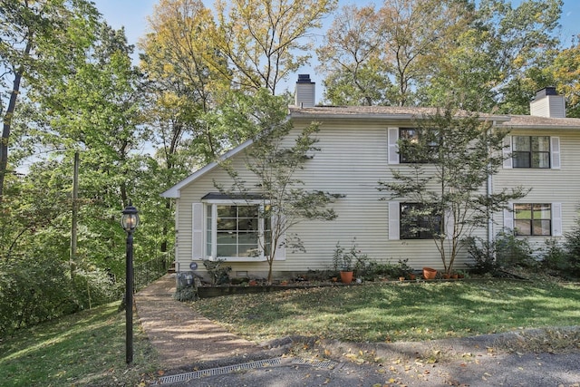 view of side of property with a lawn