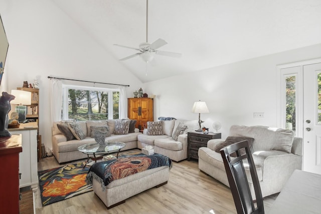 living room with ceiling fan, light wood-type flooring, and high vaulted ceiling