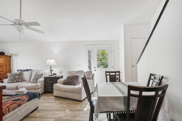 dining area with light wood-type flooring and ceiling fan