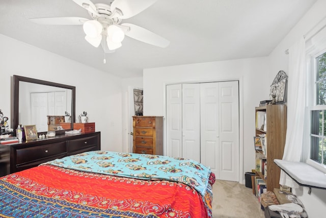 carpeted bedroom featuring a closet and ceiling fan