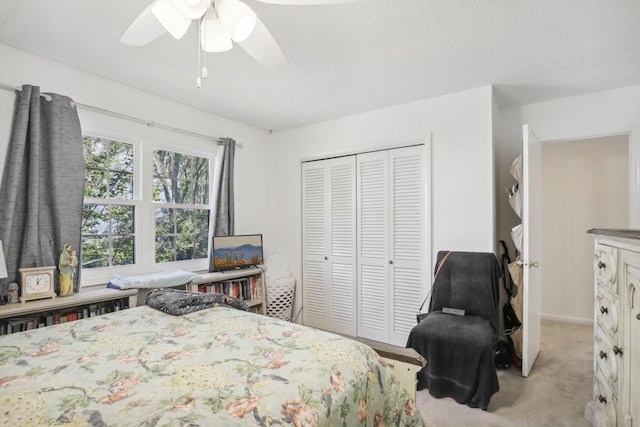 carpeted bedroom featuring a closet and ceiling fan