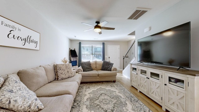 living room featuring ceiling fan and light hardwood / wood-style floors