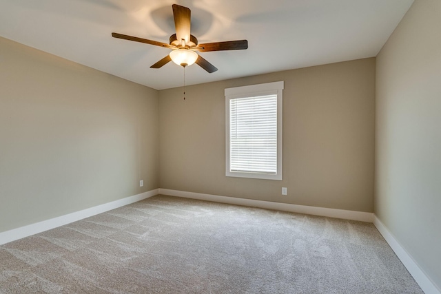 spare room featuring ceiling fan and light colored carpet