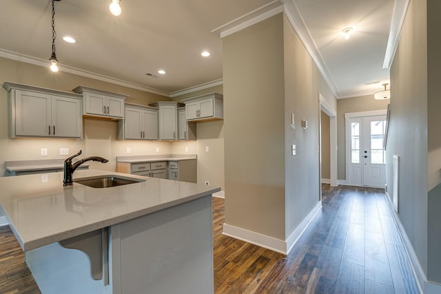 kitchen featuring sink, gray cabinetry, light stone counters, and dark hardwood / wood-style floors