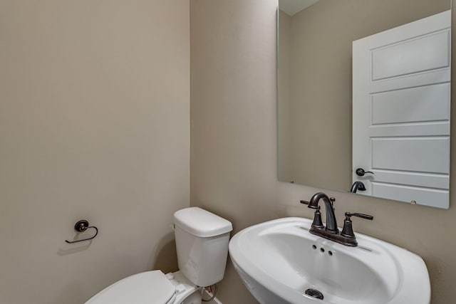 bathroom featuring sink and toilet