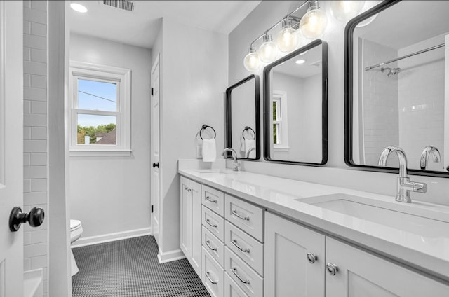 bathroom featuring toilet, tile patterned flooring, and vanity