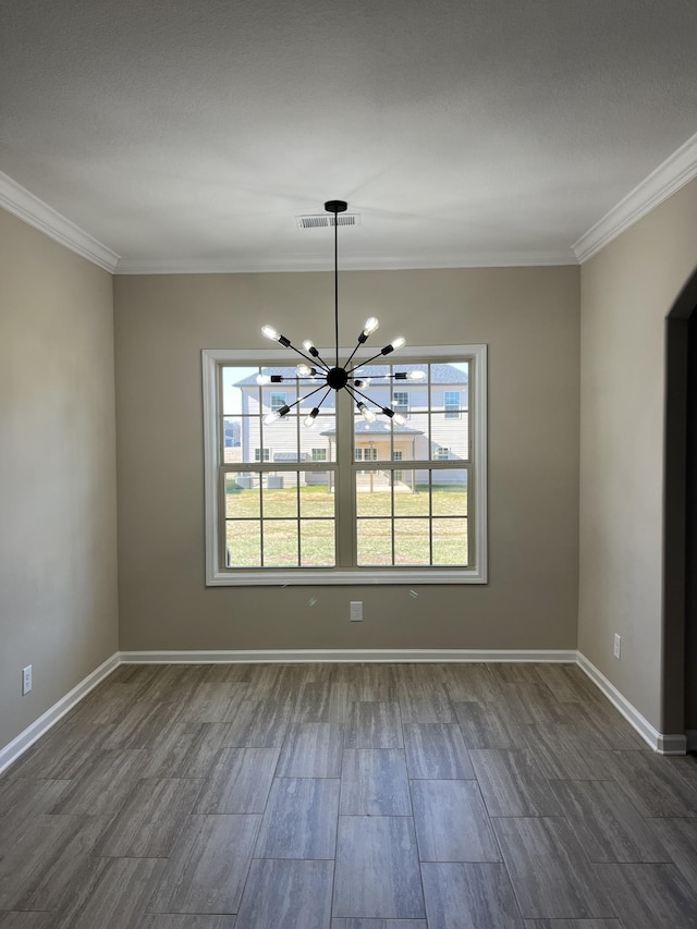 unfurnished dining area with an inviting chandelier and crown molding