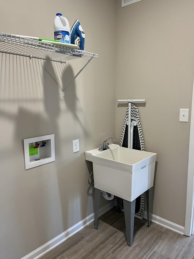 laundry area with washer hookup and hardwood / wood-style flooring