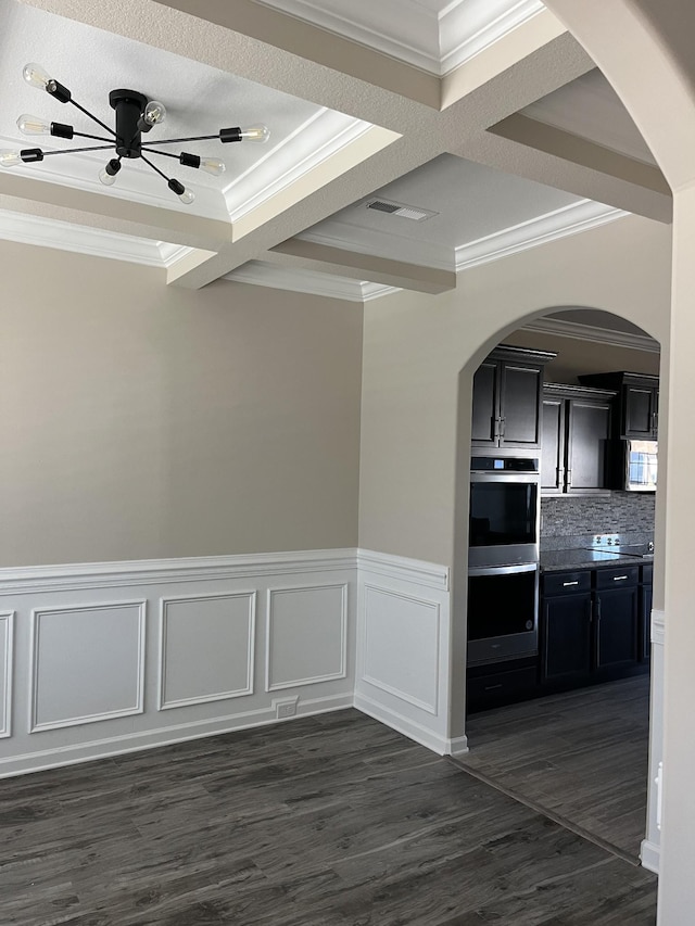 kitchen featuring coffered ceiling, crown molding, double oven, decorative backsplash, and beam ceiling