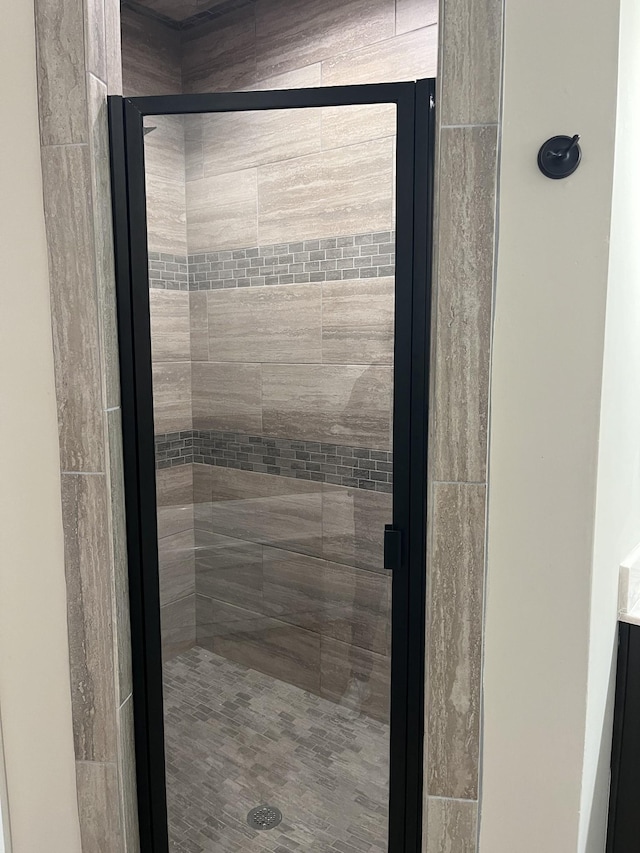 bathroom featuring a shower with shower door