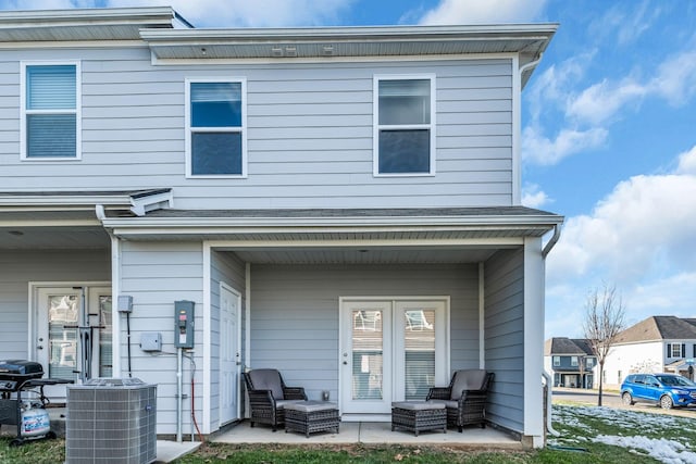 back of property featuring cooling unit and a patio area