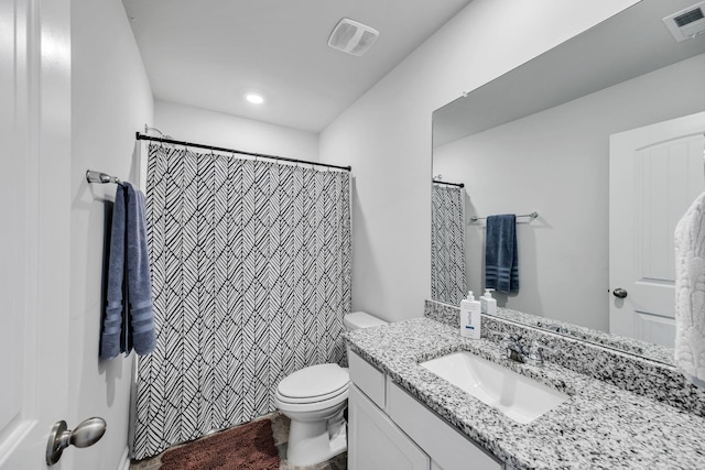 bathroom with toilet, vanity, and curtained shower