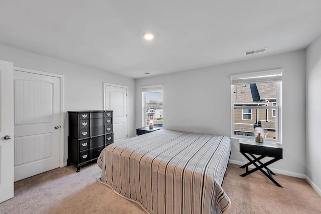 carpeted bedroom featuring multiple windows