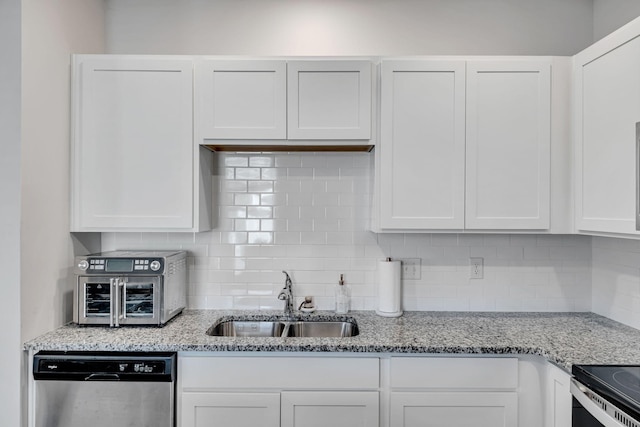 kitchen with sink, white cabinetry, dishwasher, decorative backsplash, and light stone countertops