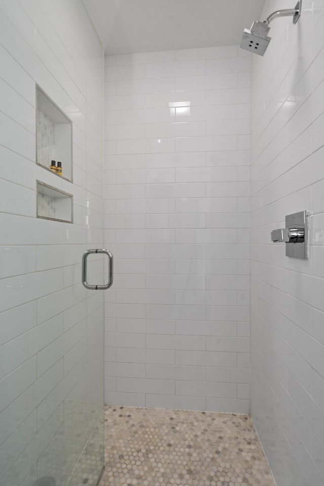 bathroom with a shower with shower door