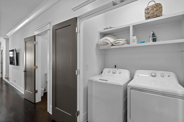 laundry area with dark hardwood / wood-style flooring and washing machine and dryer