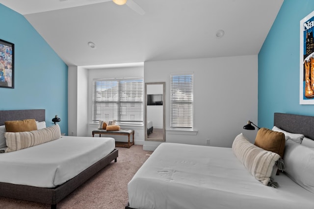 carpeted bedroom featuring vaulted ceiling and ceiling fan