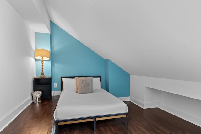 bedroom with dark hardwood / wood-style floors and vaulted ceiling