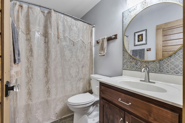 bathroom featuring toilet and vanity