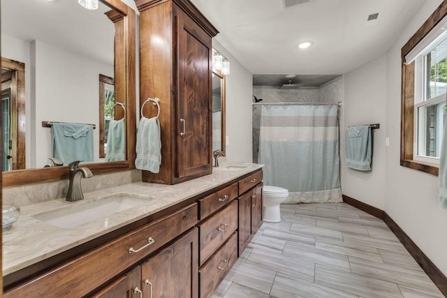 bathroom featuring toilet, a shower with curtain, and vanity