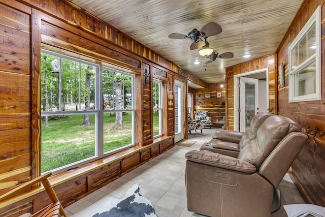 sunroom / solarium with wooden ceiling and ceiling fan