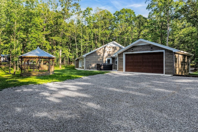 single story home featuring a gazebo and a front yard