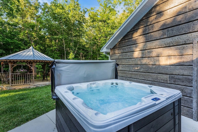 exterior space with a gazebo and a hot tub