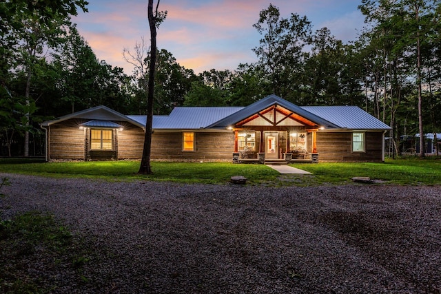 view of front of property featuring a yard and covered porch