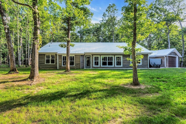 ranch-style house featuring a garage and a front yard