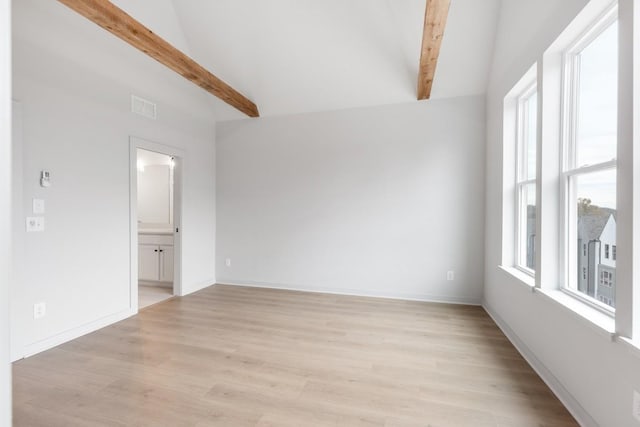 unfurnished room with light hardwood / wood-style floors and vaulted ceiling with beams