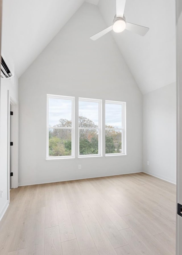 bonus room with high vaulted ceiling, ceiling fan, a wall mounted air conditioner, and light hardwood / wood-style floors