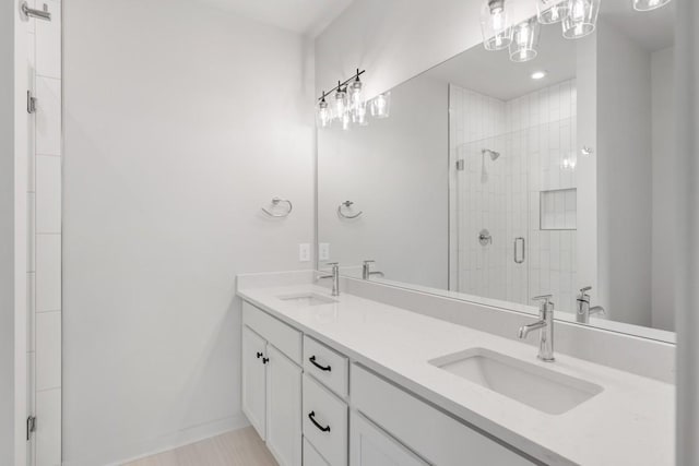 bathroom featuring walk in shower and vanity