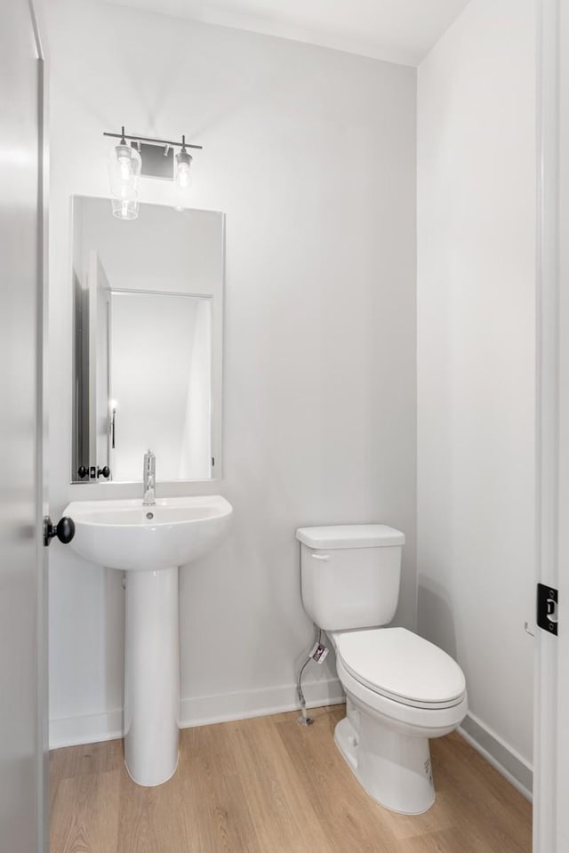 bathroom featuring hardwood / wood-style floors and toilet