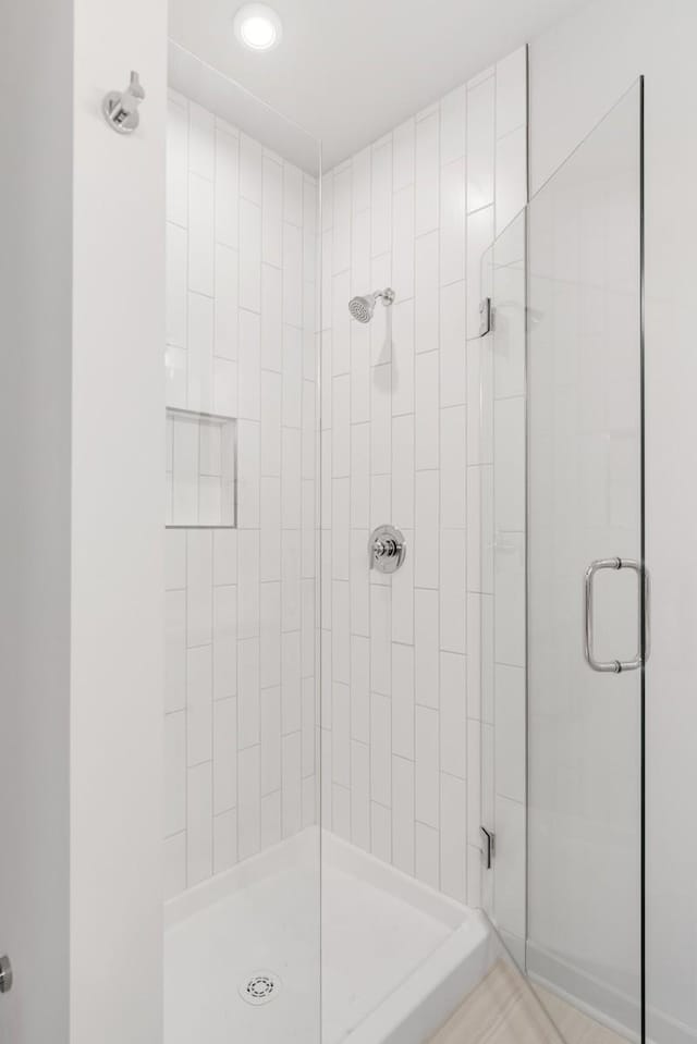 bathroom with walk in shower and tile patterned floors