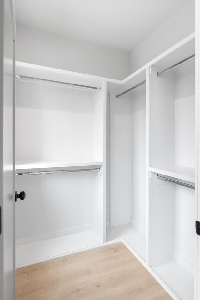 walk in closet featuring hardwood / wood-style flooring