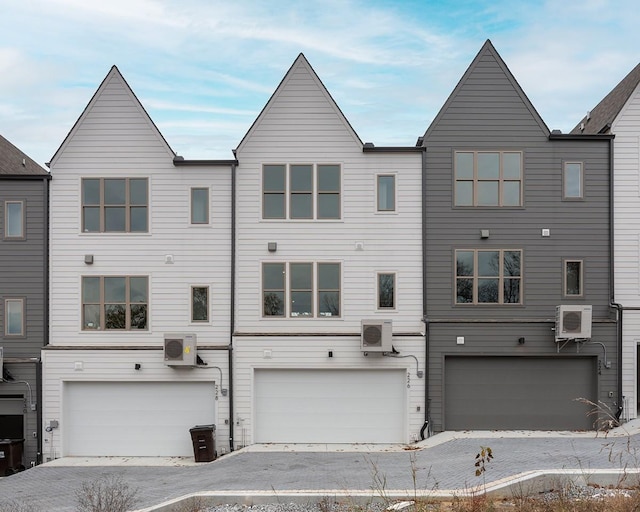 view of front of house with ac unit and a garage