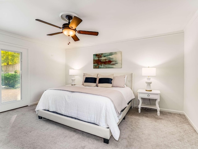 carpeted bedroom featuring ceiling fan and ornamental molding